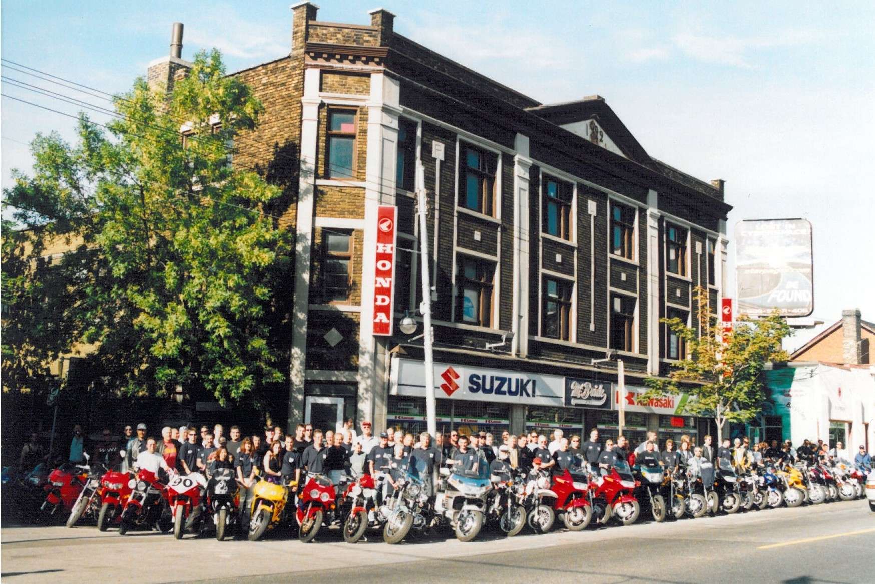 The McBride Cycle storefront in Toronto with staff and rows of motorcycles out front